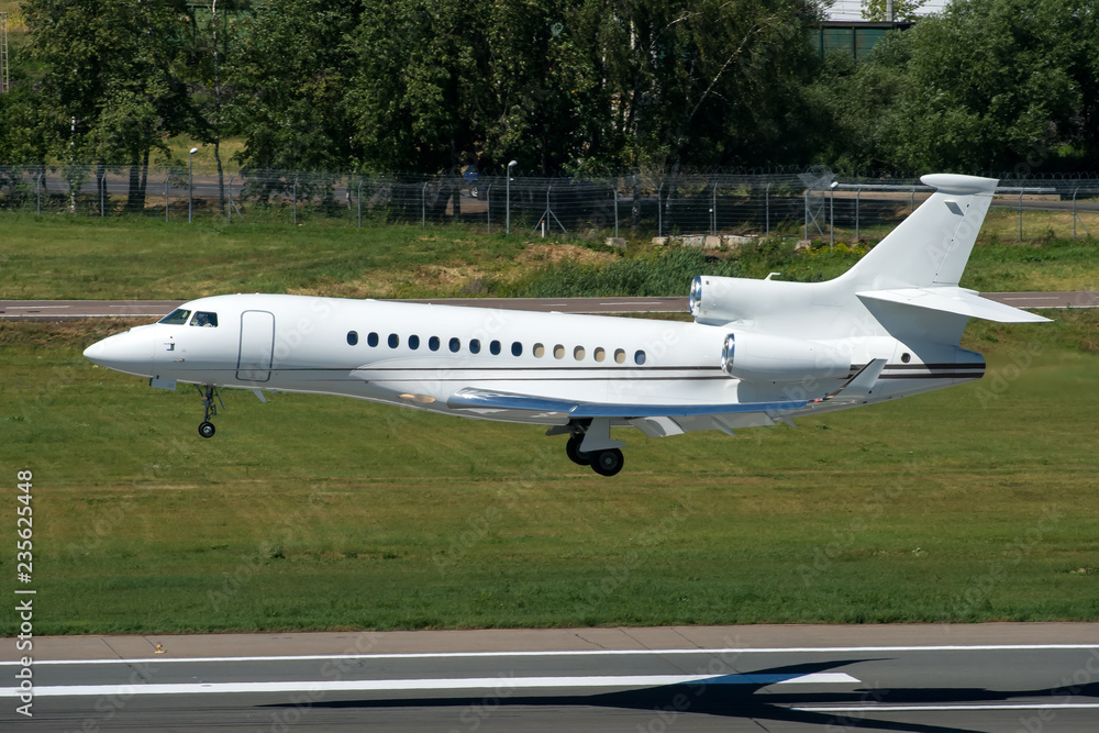 White modern private jet landing at airport White modern private jet landing at airport