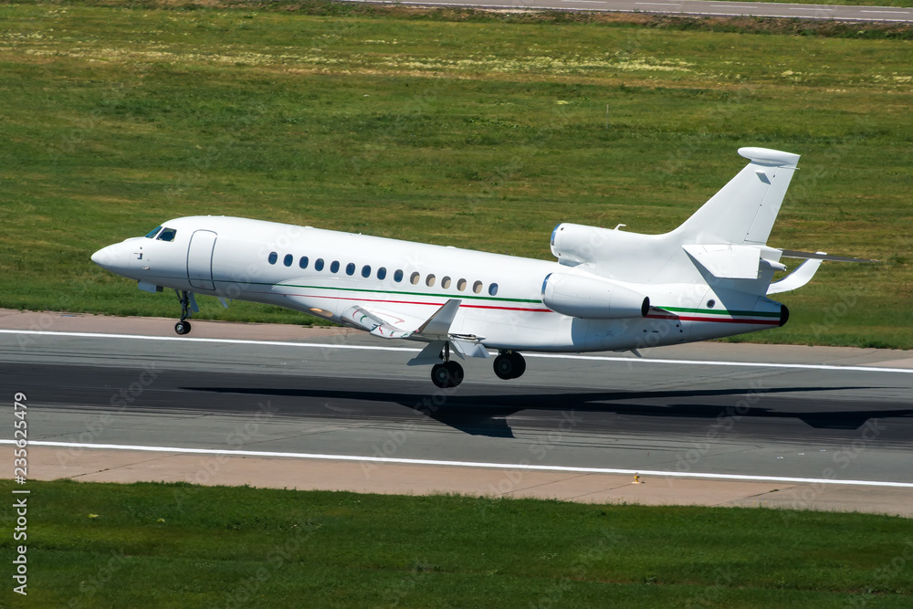 White modern private jet landing at airport White modern private jet landing at airport