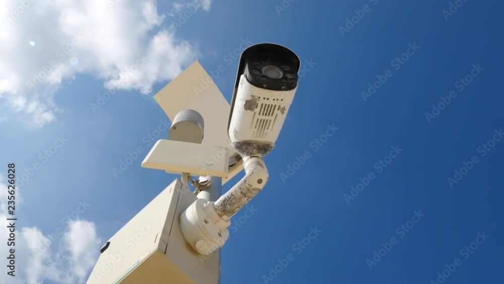 Outdoor security camera on blue sky background Outdoor security camera on blue sky background