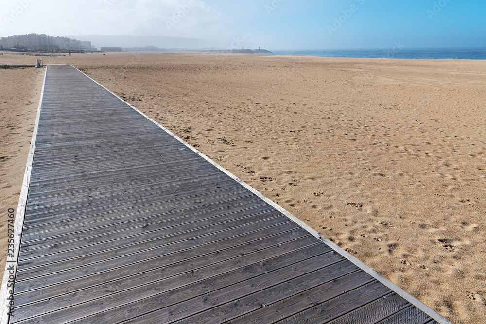 Wooden path by the ocean in Nazare, Portugal.