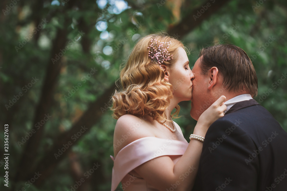 bride and groom kissing in the summer forest bride and groom kissing in the summer forest