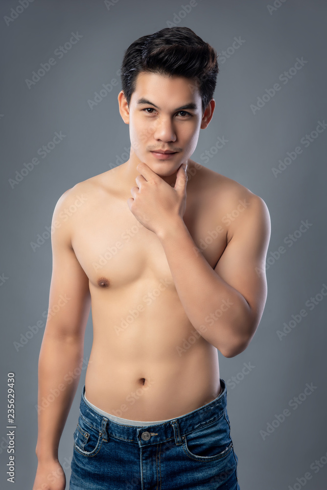 Portrait of shirtless young handsome Asian man studio shot