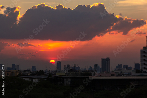 Sunset over the buildings in city.Skyline view of cityscape with sunlight