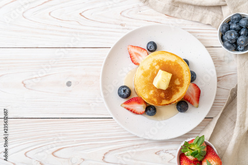фотографія pancake with strawberries, blueberries and honey