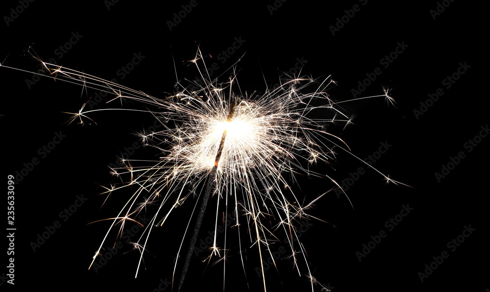 Ignited sparkler isolated on black background with clipping path
