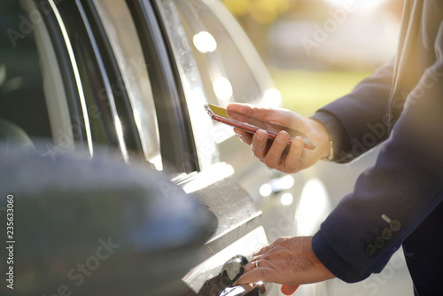 Φωτογραφία Closeup of unlocking door system with smartphone