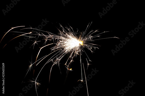 Ignited sparkler isolated on black background with clipping path