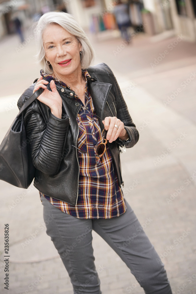  Modern senior woman in town wearing leather jacket