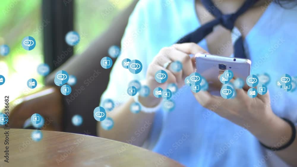 Hand using smartphone with social media icons animation across screen. Hand using smartphone with social media icons animation across screen.