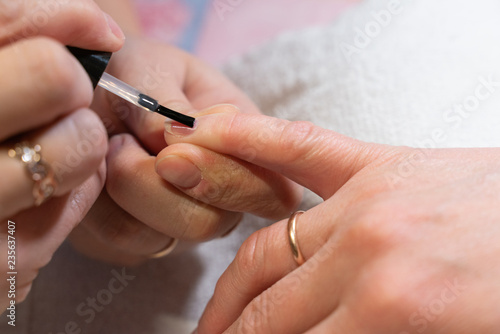 the master applies the Polish on the nails. the process of creating a manicure hands close-up. nail care