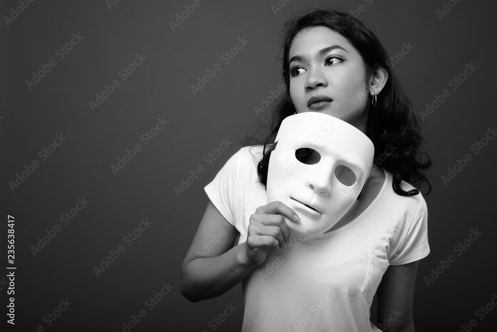 Portrait young beautiful woman holding mask Stock Photo | Adobe Stock