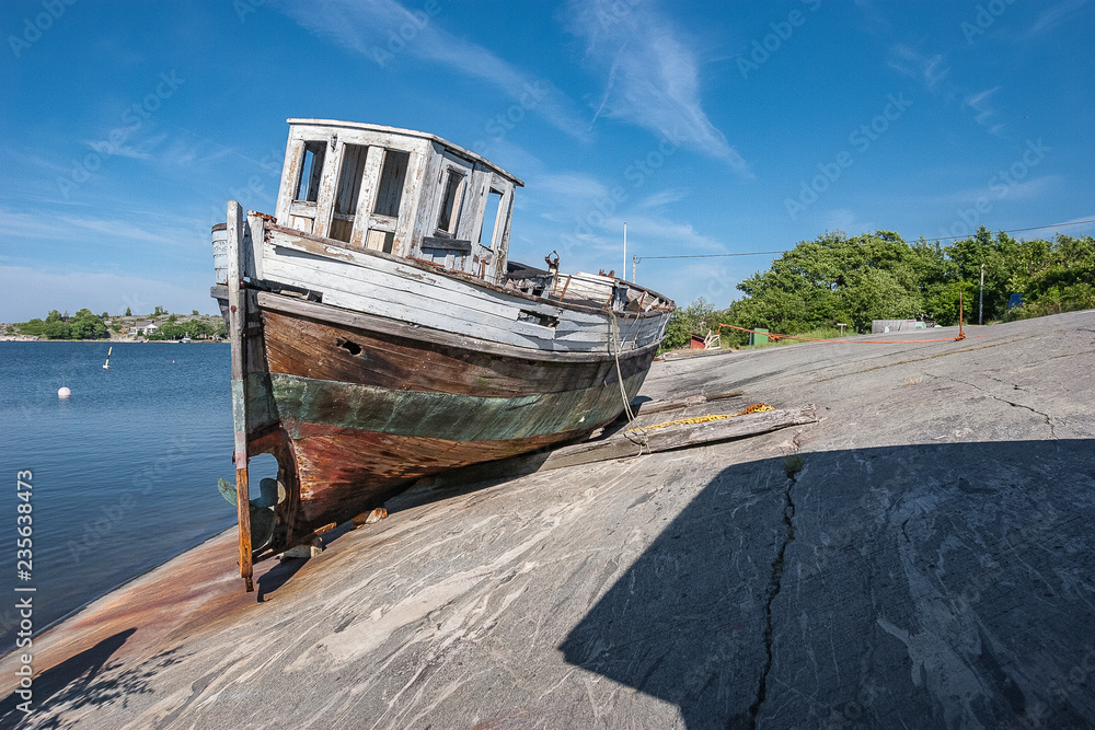 famous wreck of a fishing boat on the rocks of Koekar Island, Aland Islands between Sweden an Finland famous wreck of a fishing boat on the rocks of Koekar Island, Aland Islands between Sweden an Finland