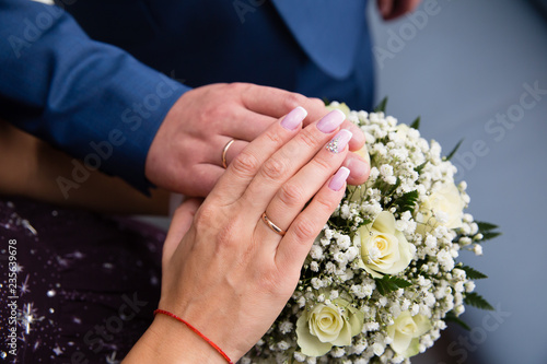 Bride and groom hands with wedding rings