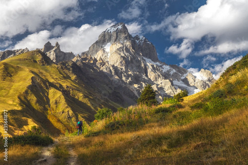 Backpacker tourist on a rout in mountains