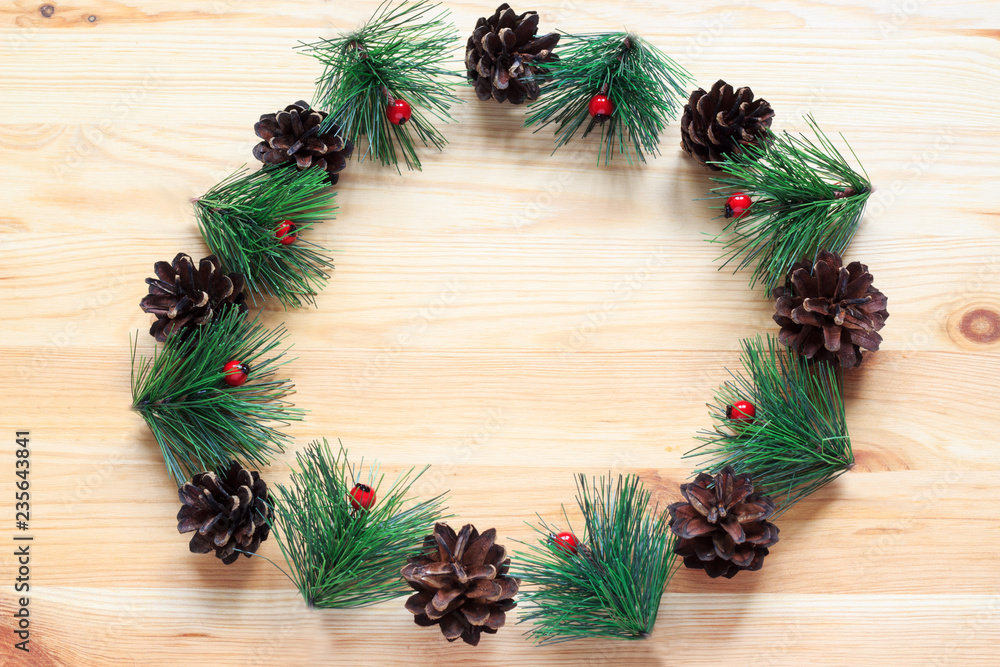 Christmas wreath on wooden background. Christmas wreath in minimalist style. Copy space. Top view. Christmas wreath on wooden background. Christmas wreath in minimalist style. Copy space. Top view.