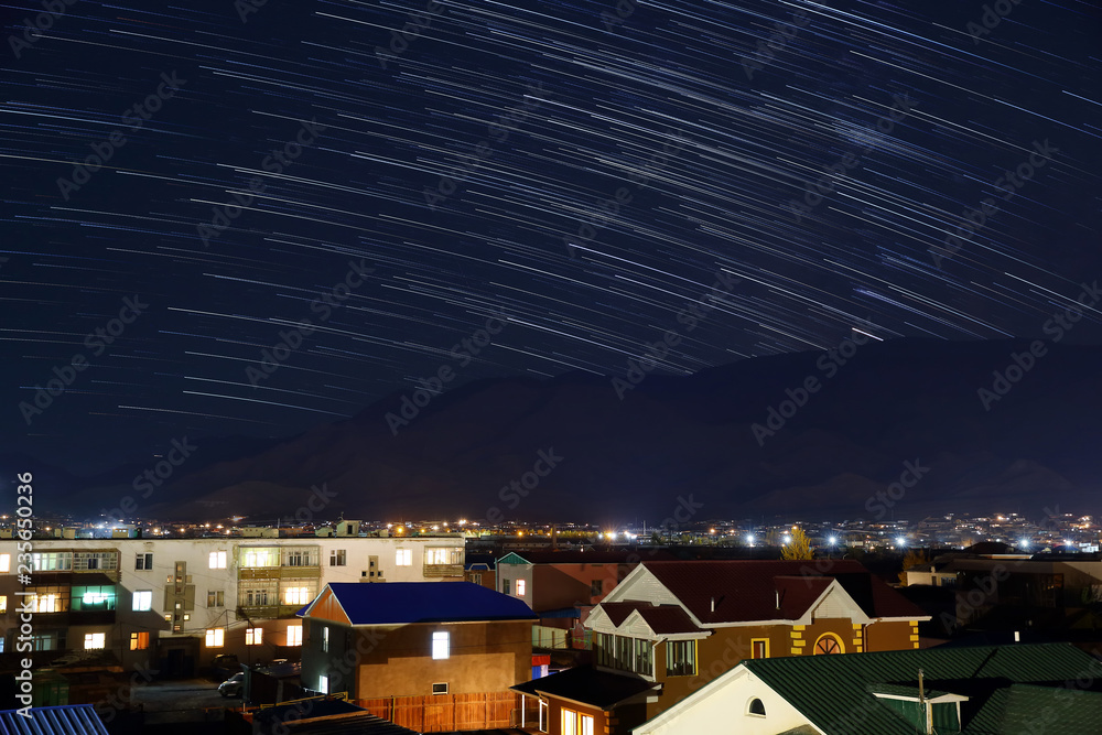 Night of star trail over home or building after mountain in the city of Bayan-Ulgii of Western Mongolia