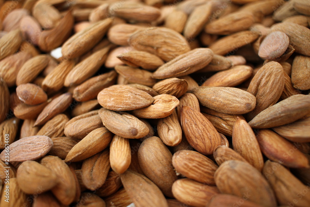 Almonds. Background of big raw peeled almonds situated arbitrarily. Nuts wallpaper pattern. Clipping path. Peeled almonds close up. For vegetarians. Nut pattern. Almonds. Background of big raw peeled almonds situated arbitrarily. Nuts wallpaper pattern. Clipping path. Peeled almonds close up. For vegetarians. Nut pattern.