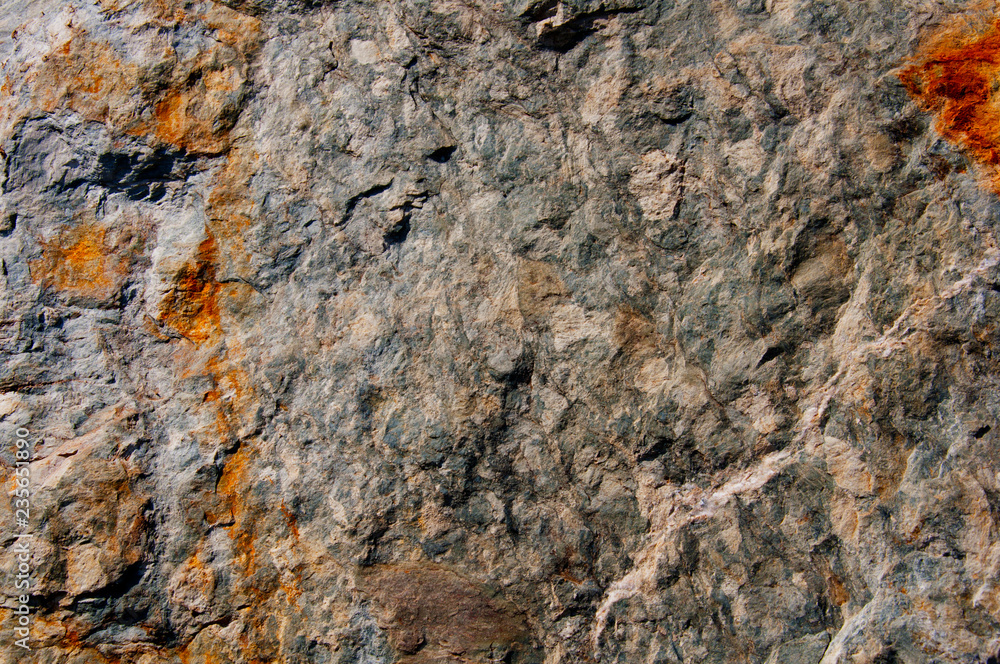 Grey stone surface with rusty marks