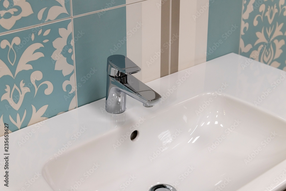 Fototapeta premium Fragment of conventional faucet in the bathroom