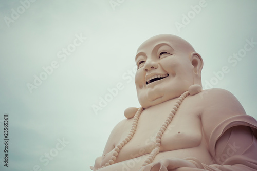 Massive statue of the Sitting Smiling Buddha at the Vinh Tranh Pagoda in My Tho, the Mekong Delta