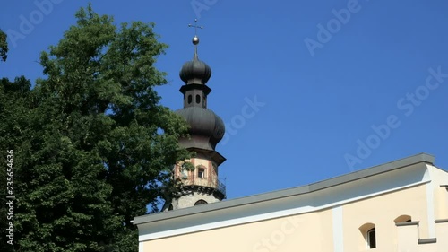 gothic bell tower of a church in the small town of Brunico in South Tyrol photo