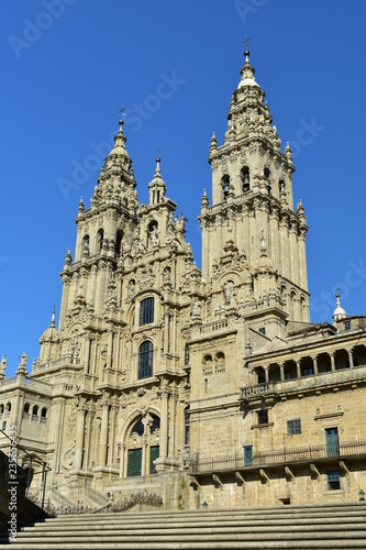 Cathedral, side view from stone stairs. Obradoiro facade and towers with blue sky, Santiago de Compostela, Spain. © JB