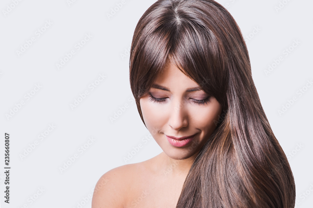 Studio portrait of a beautiful young woman with brown hair. Pretty model girl with perfect fresh clean skin. Beauty and skin care concept Studio portrait of a beautiful young woman with brown hair. Pretty model girl with perfect fresh clean skin. Beauty and skin care concept