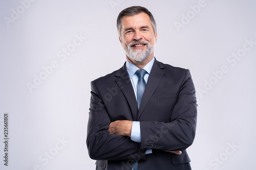 Happy satisfied mature businessman looking at camera isolated on white background.