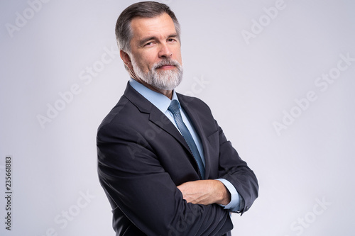 Happy satisfied mature businessman looking at camera isolated on white background.