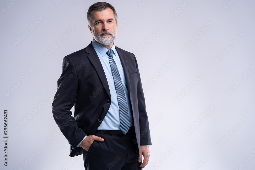 Fototapeta premium Happy satisfied mature businessman looking at camera isolated on white background.