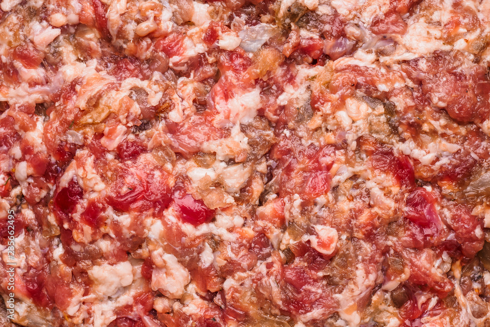 Fresh homemade raw chopped beef and pork  meat.  Minced meat texture, close up background - top view.