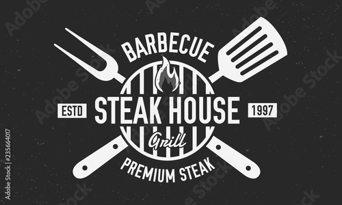 Steak House logo. BBQ logo with barbecue grill, spatula and grill fork isolated on black background. Vector emblem template.