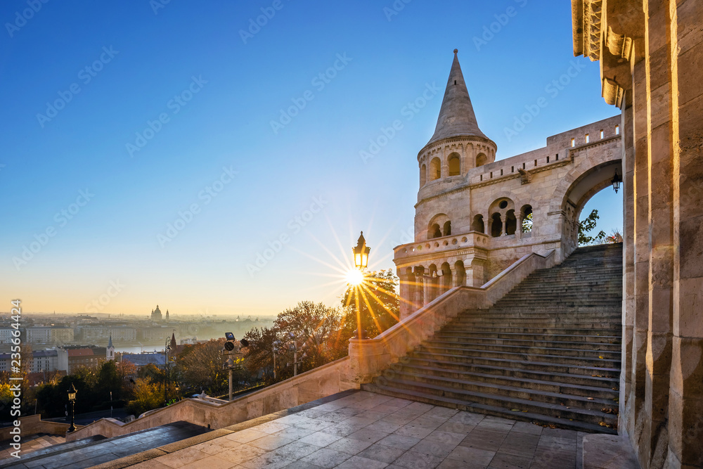 Budapest, Hungary - Entrance steps and the south tower of the Fisherman's Bastion (Halaszbastya) at sunrise and clear blue sky