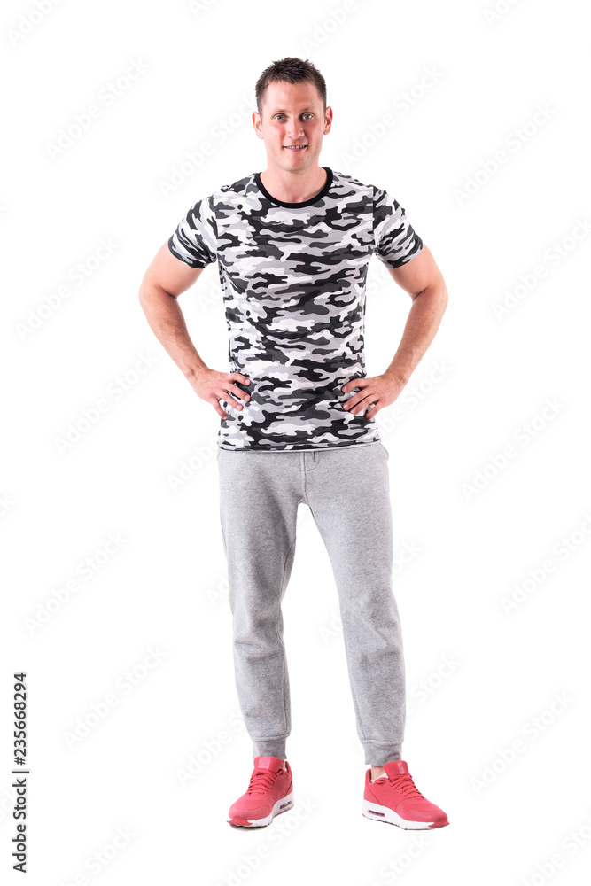 Relaxed young friendly handsome man smiling with arms on hips. Full body isolated on white background. Relaxed young friendly handsome man smiling with arms on hips. Full body isolated on white background.