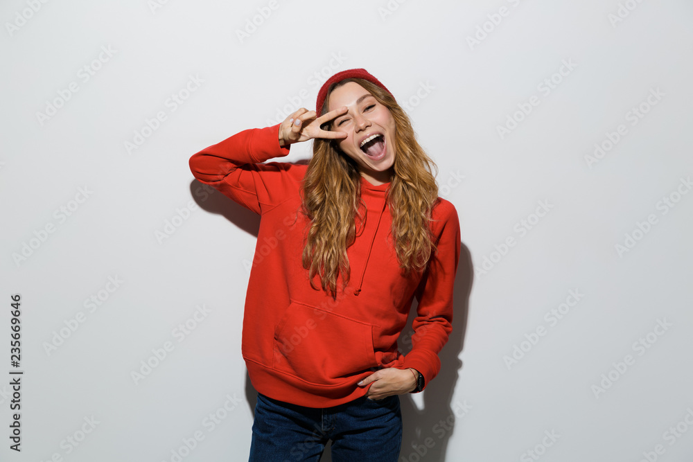 Portrait of a cheerful young woman wearing hoodie Portrait of a cheerful young woman wearing hoodie