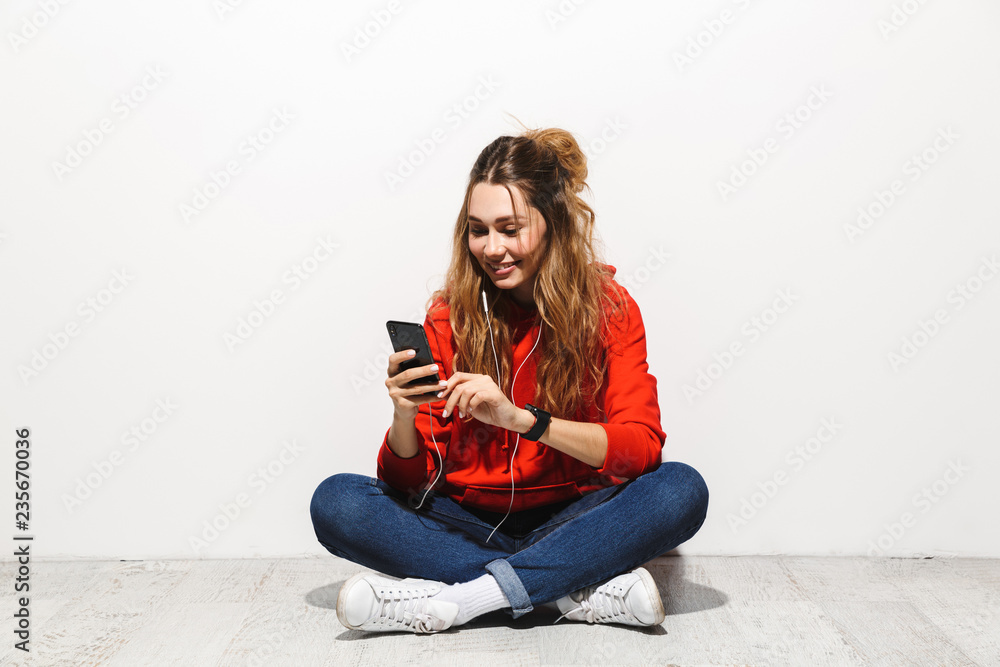 Portrait of a happy young woman wearing hoodie Portrait of a happy young woman wearing hoodie