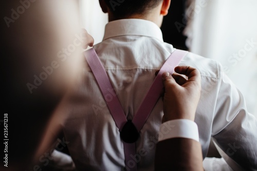 groom in white wedding dress