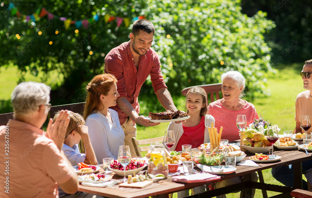 leisure, holidays and people concept - happy family having festive dinner or barbecue party at summer garden leisure, holidays and people concept - happy family having festive dinner or barbecue party at summer garden