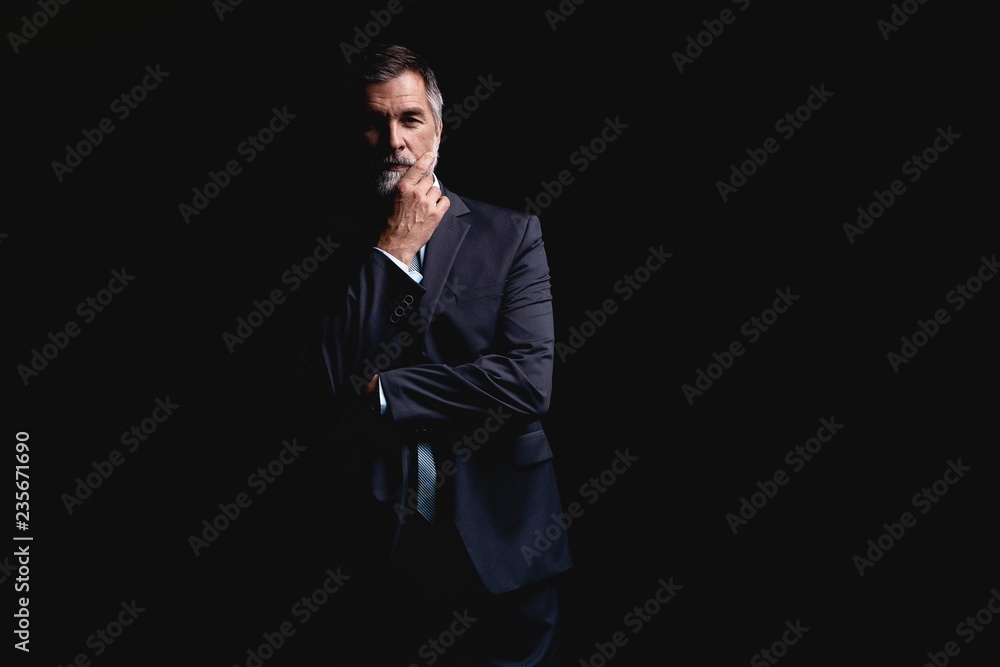 Handsome mature business man isolated on black background Handsome mature business man isolated on black background