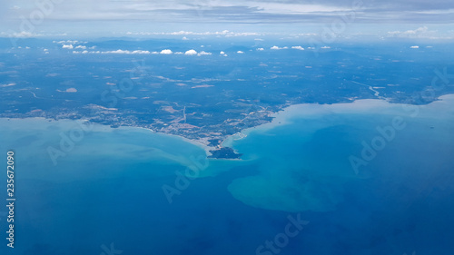 Aerial view from plane. Sea shore and city in tropics. Port Dickson, Malaysia, near Kuala Lumpur International Airport.
