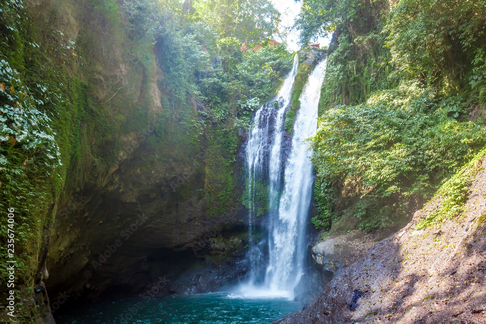 Famous Aling-Aling waterfall without people among green tropical jungle on the north of Bali island, Indonesia