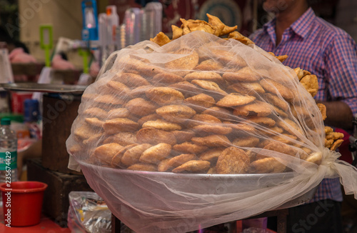 Photography Indian street food vendor sell Fresh Samosa  and kachoris,a popular variety in a