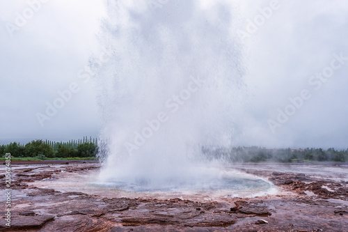Magnificent Strokkur Geyser erupts the fountain of azure water, popular tourist attraction, Haukadalur geothermal area, Iceland