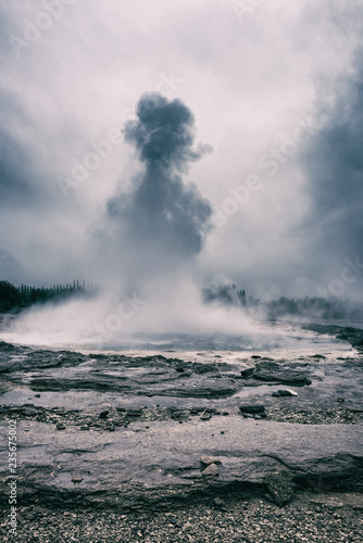 Magnificent Strokkur Geyser erupts the fountain of water, dramatic vintage image of popular tourist attraction, Haukadalur geothermal area, Iceland. Vertical image