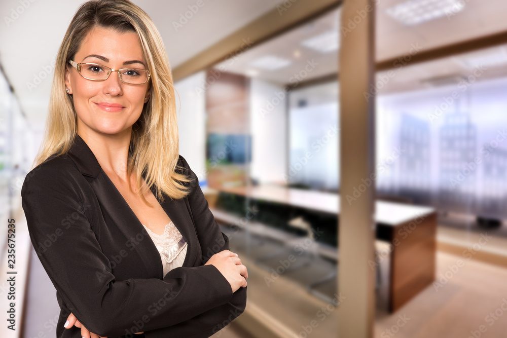Brazilian business woman looking at camera in blurry office background. Copy space. Brazilian business woman looking at camera in blurry office background. Copy space.