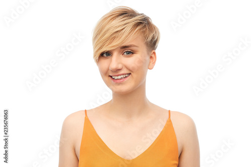 fashion, style and people concept - portrait of happy smiling teenage girl over white background