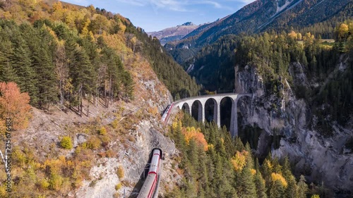 Wallpaper Mural Following a train on the viaduct Landwasser in Swiss mountains during the autumn. Filmed with the DJI Inspire 2 drone in 5.2k RAW resolution and downscaled to 4k. Torontodigital.ca