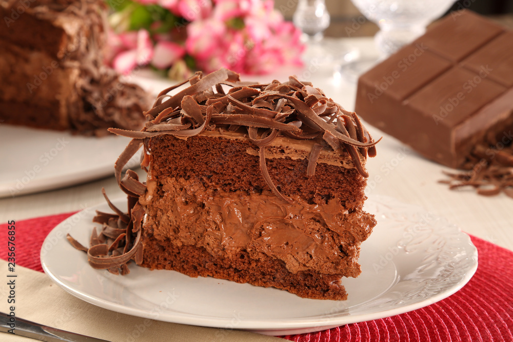 Macro close up of appetizing dark chocolate cake with out of focus cake in background. Macro close up of appetizing dark chocolate cake with out of focus cake in background.