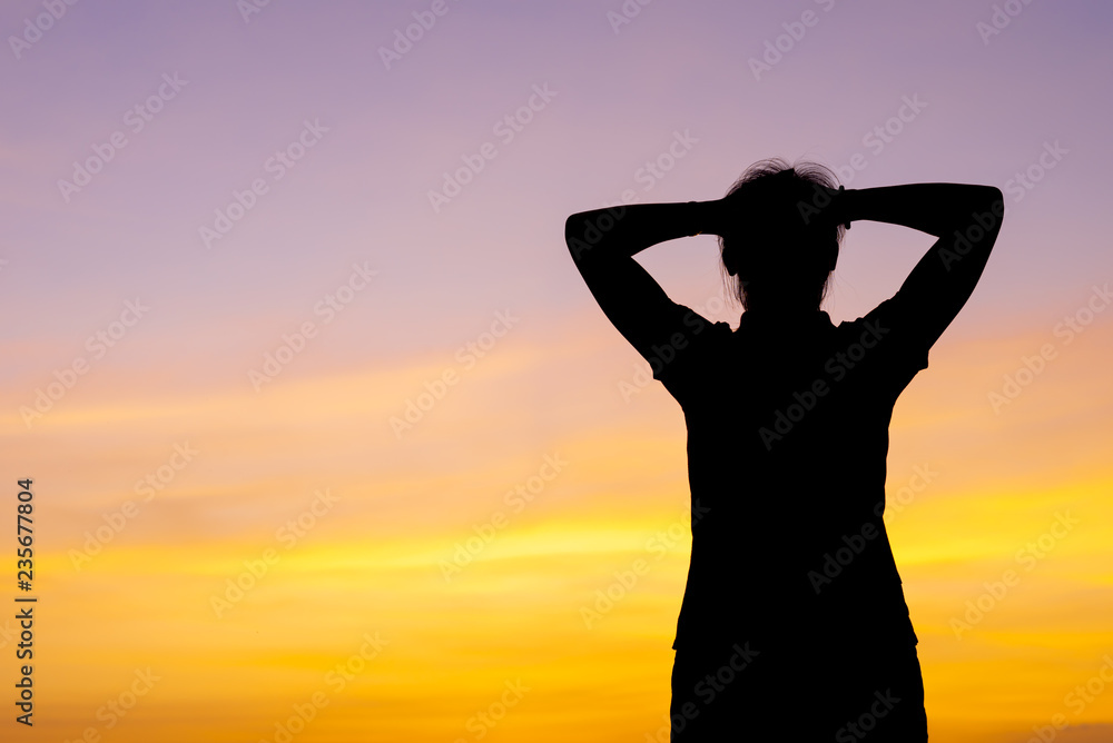 Fototapeta premium Young woman relaxing with sunset