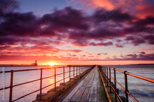 Sunrise at River Blyth Harbour, as the river reaches the North Sea between the piers in Northumberland